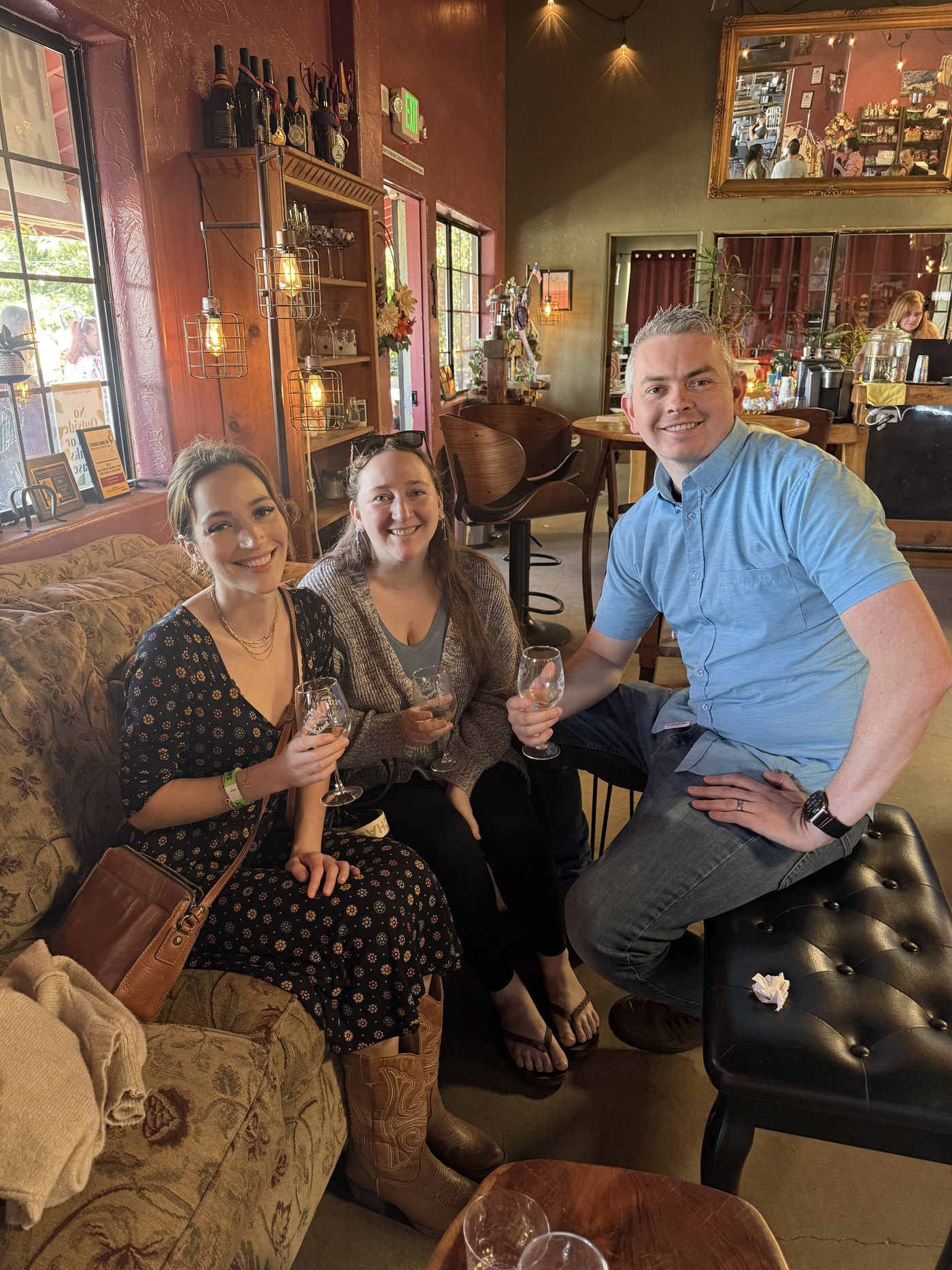 Three Wine Mob members with glasses in the Placerville tasting room