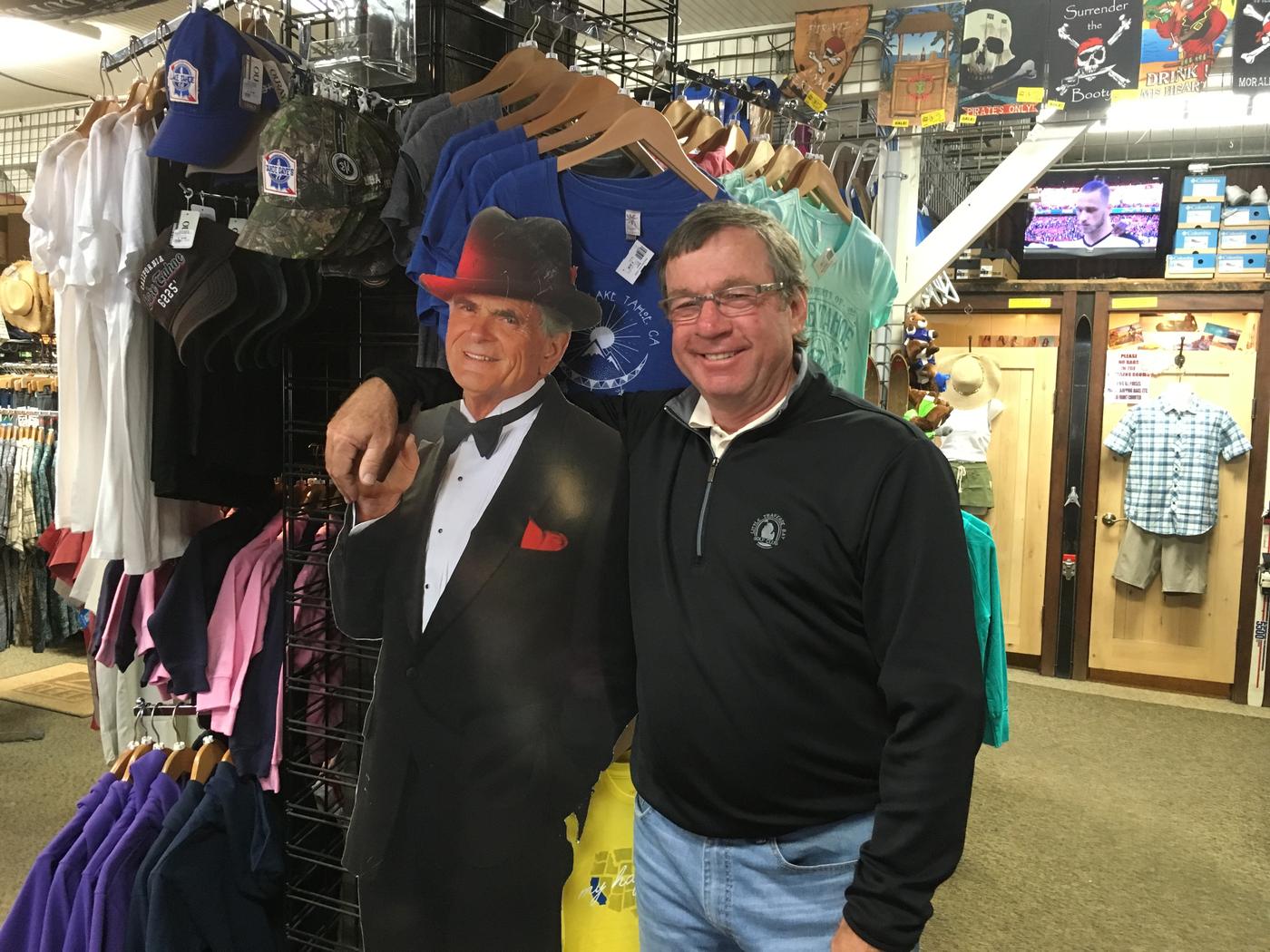 A member posing with the Sinatra cutout in the shop