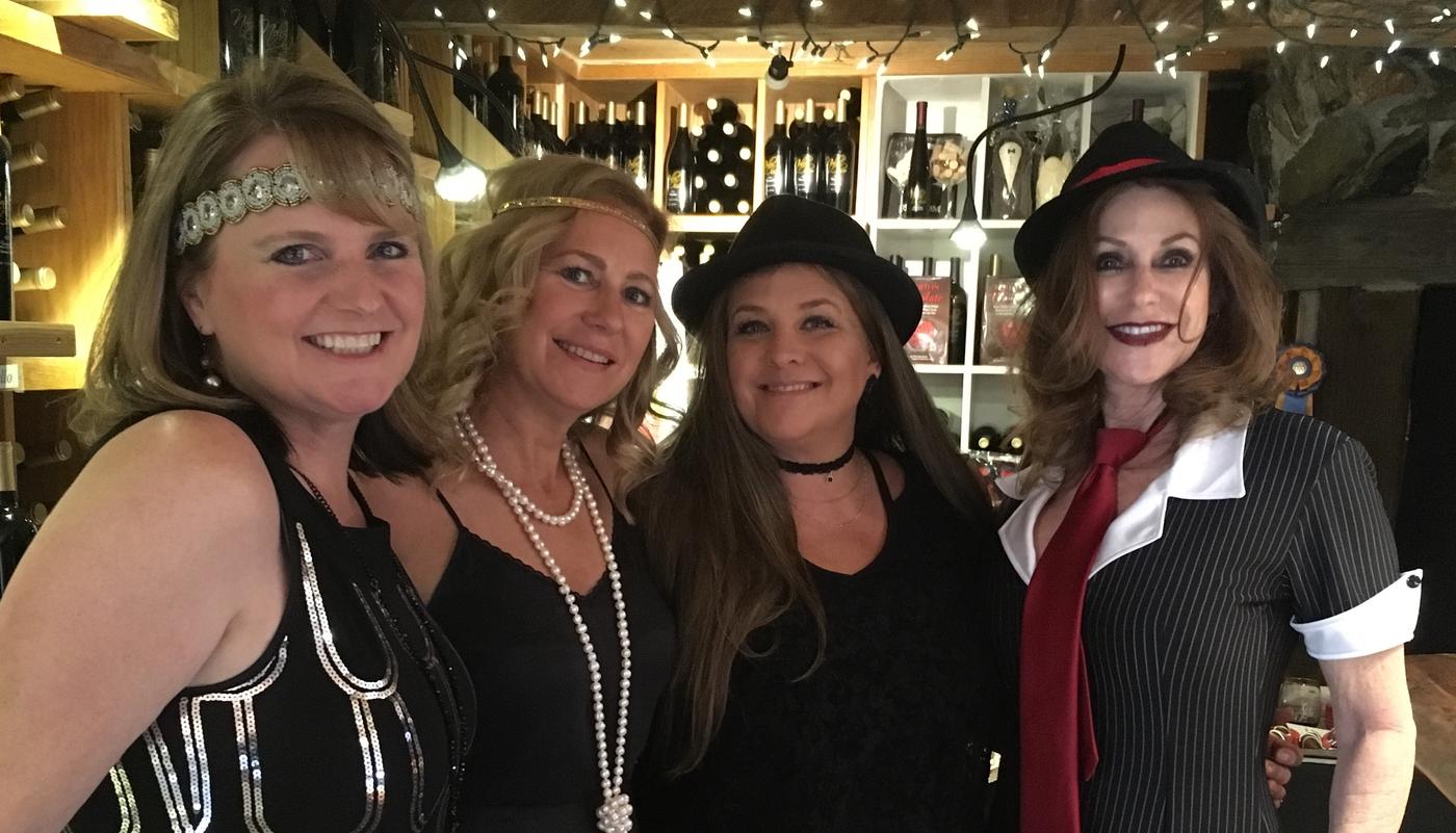 Four members in flapper pearls at the bar