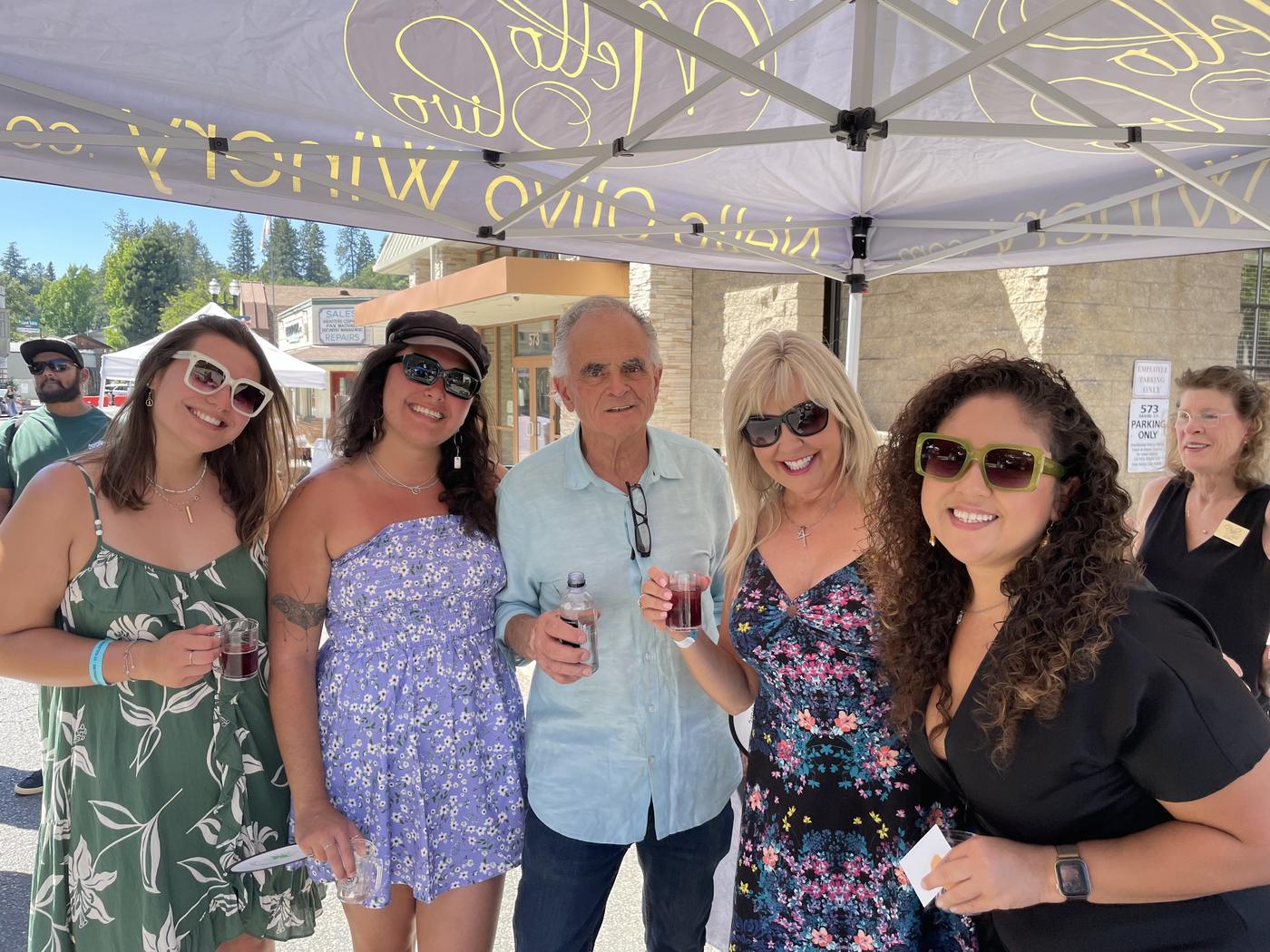 Members under the winery tent in summer dresses