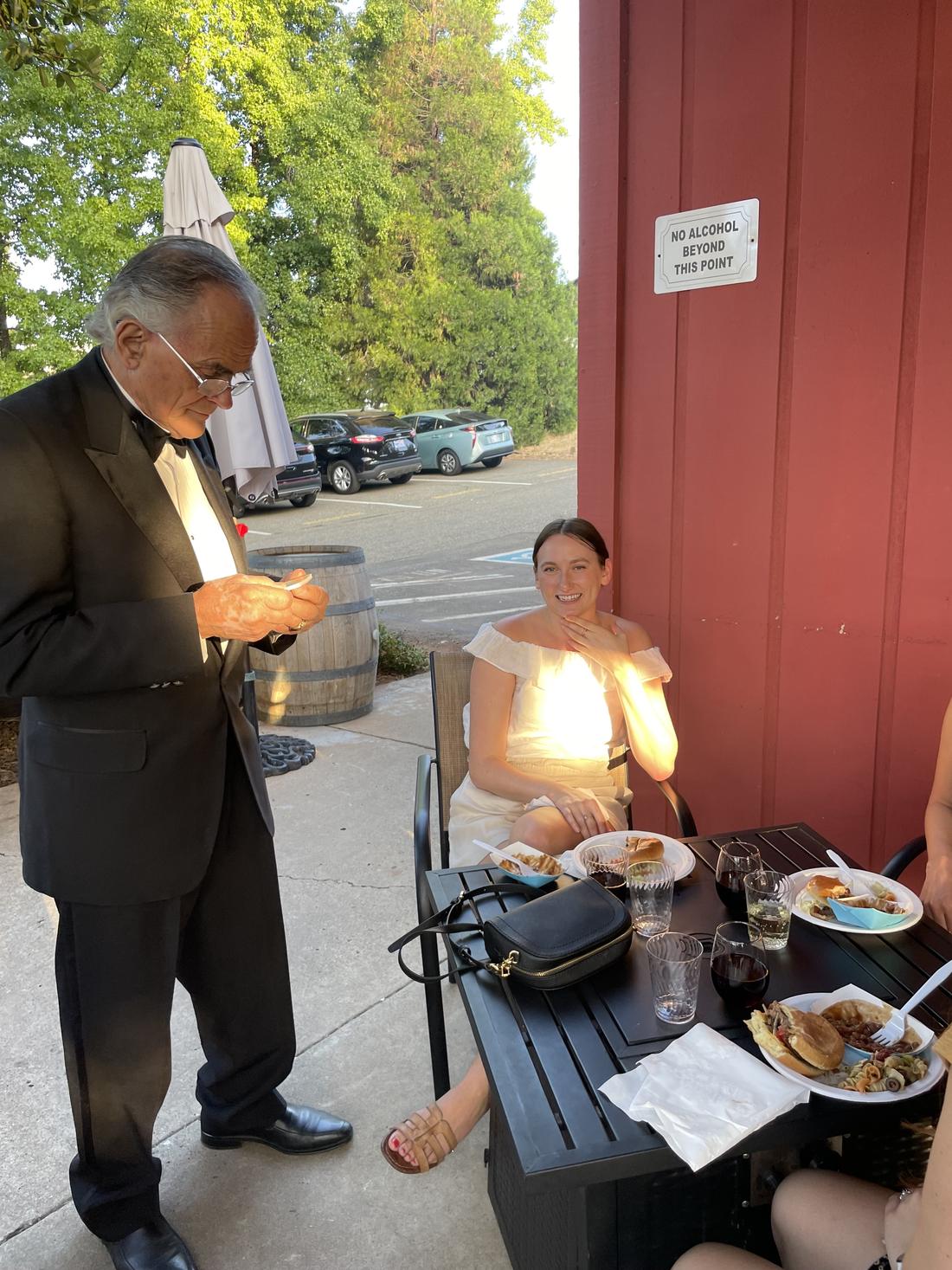 Nello checking in a guest on the patio
