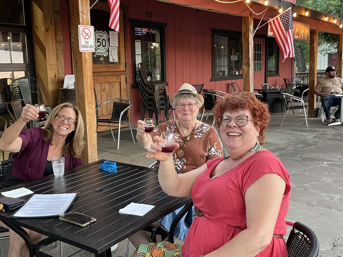Members toasting on the patio in the sun