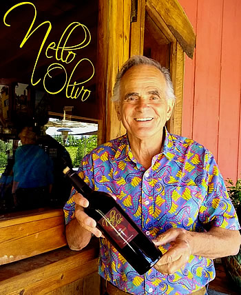 Nello holds bottle of top award-winning Sagrantino
