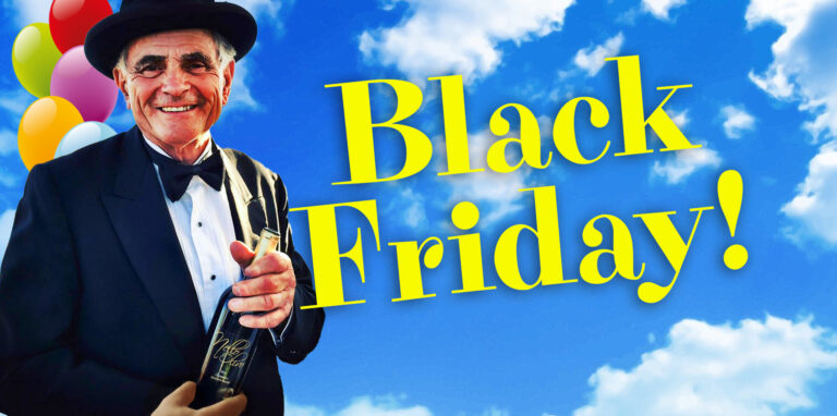 Nello with hat and wine bottle, blue skies and clouds.